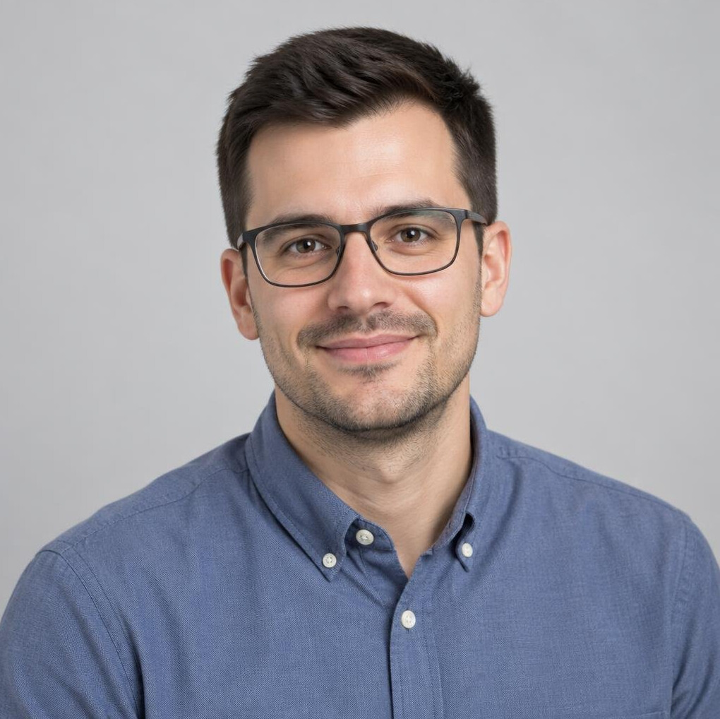 Portrait of a young man with glasses smiling softly
