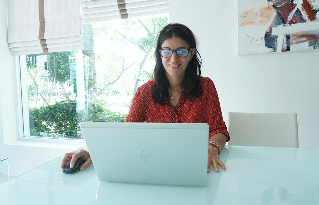woman coding at home desk
