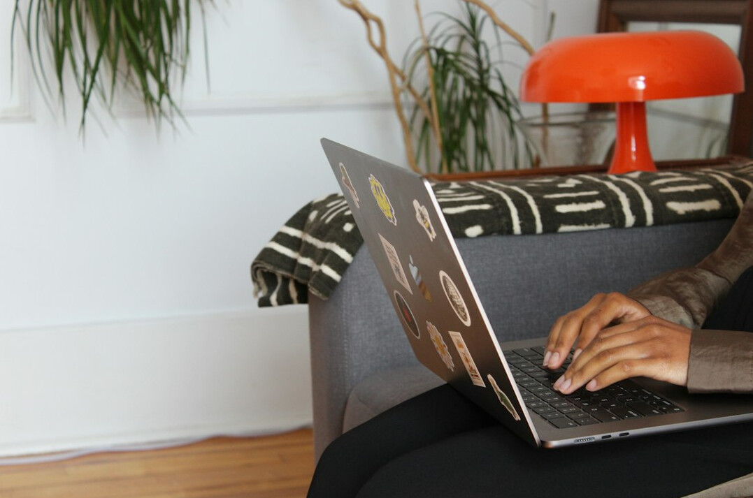 person coding on laptop at home