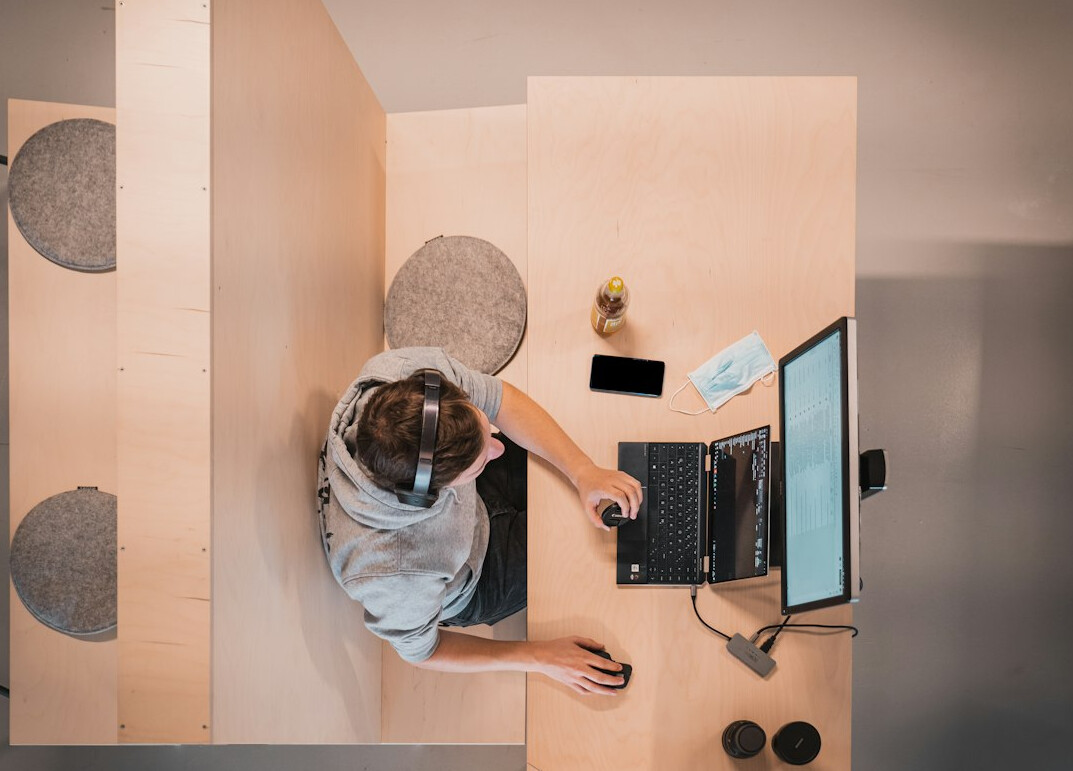 person coding on laptop at desk