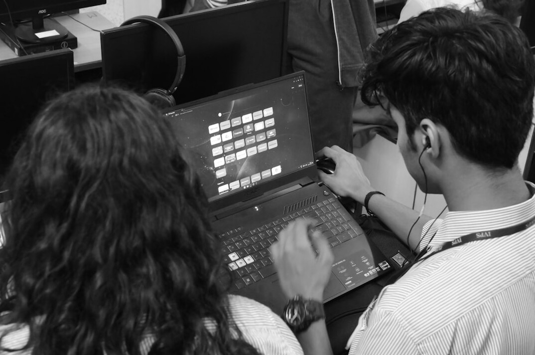 kids coding on laptops